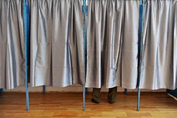 Man inside a voting booth.