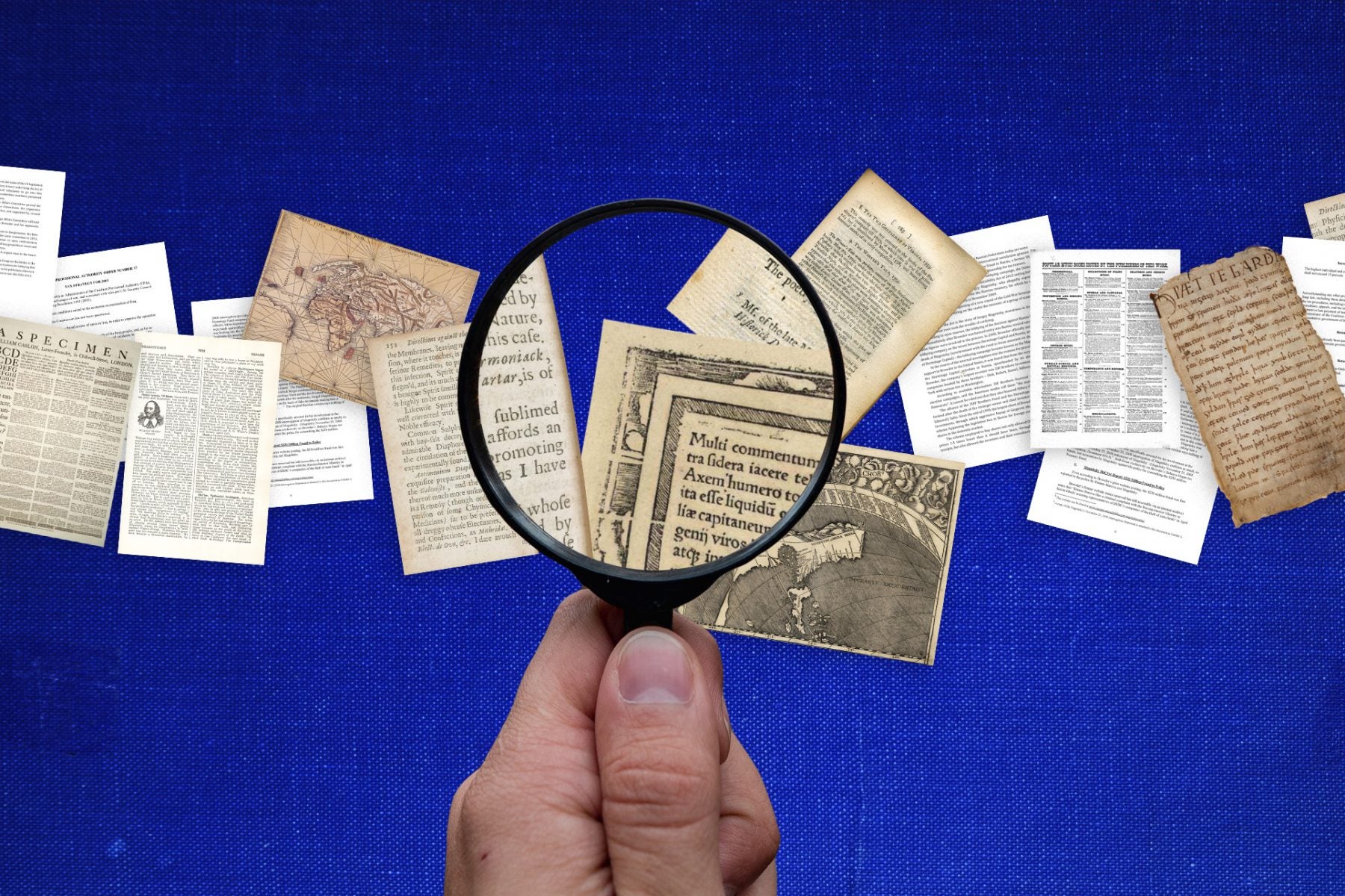 A hand holding a magnifying glass looking at pages with different fonts