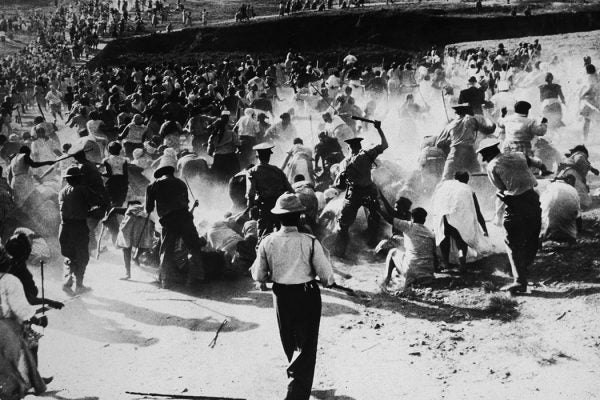 South African police beating Black women with clubs after they raided and set a beer hall on fire in protest against apartheid, Durban, South Africa, 1959