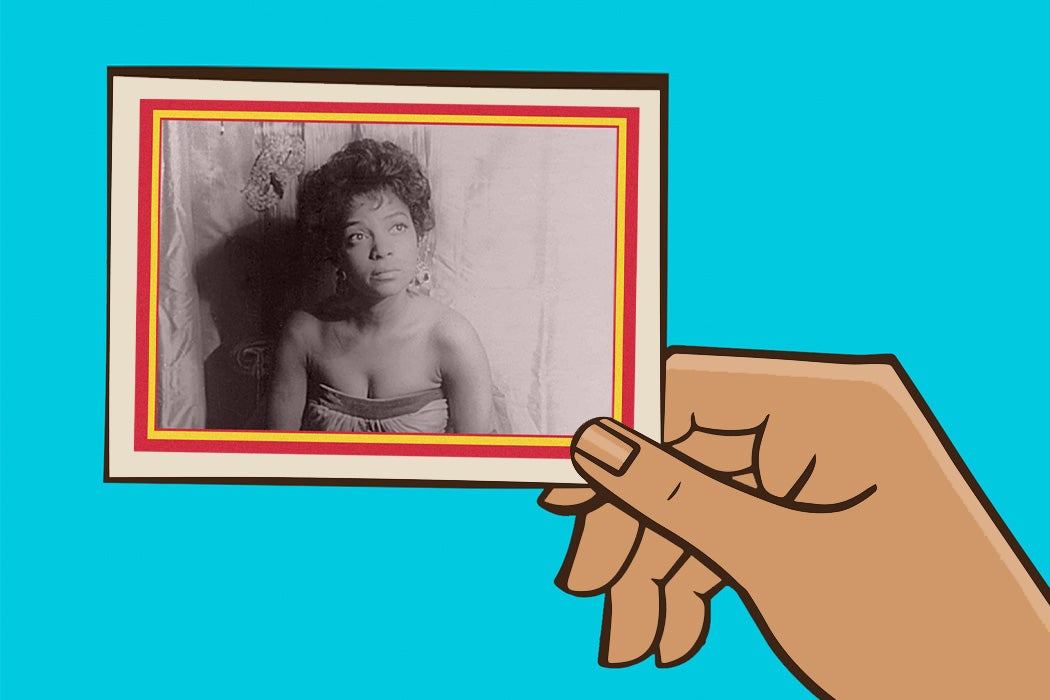 A hand holding a trading card featuring Ruby Dee