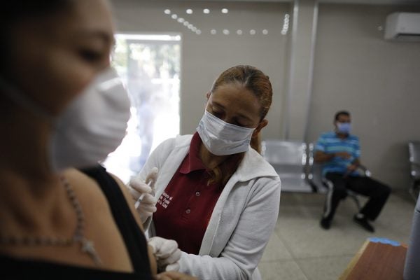A nurse applies a vaccine in Caracas, Venezuela in March, 2020
