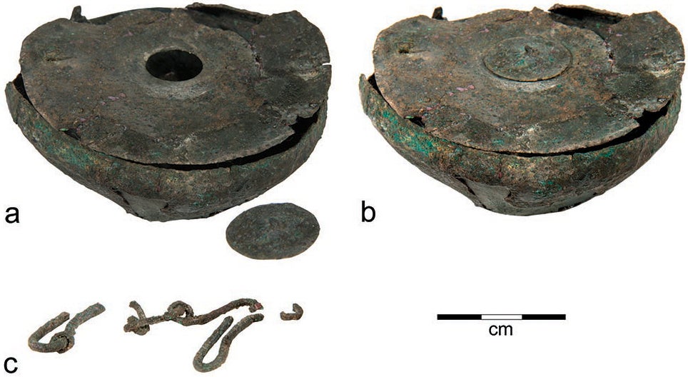 Parts of a bronze inkwell from Tel Kedesh: a, bowl with small cover removed; b, bowl with small cover in place; c, frag- ments of a chain that probably once stretched across the top of the lid