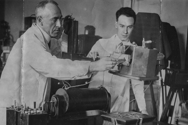 Psychic researcher Harry Price X-raying a sealed box which once belonged to religious prophetess Joanna Southcott with his assistant, August 1938