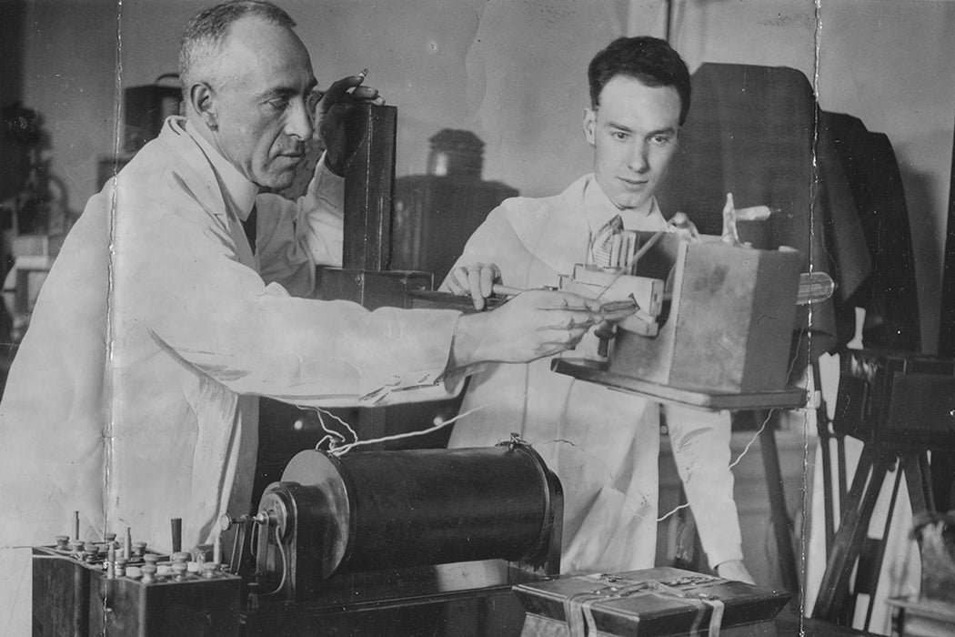 Psychic researcher Harry Price X-raying a sealed box which once belonged to religious prophetess Joanna Southcott with his assistant, August 1938