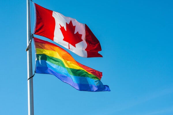 Rainbow flag flying together with Canadian flag in London, Ontario, Canada