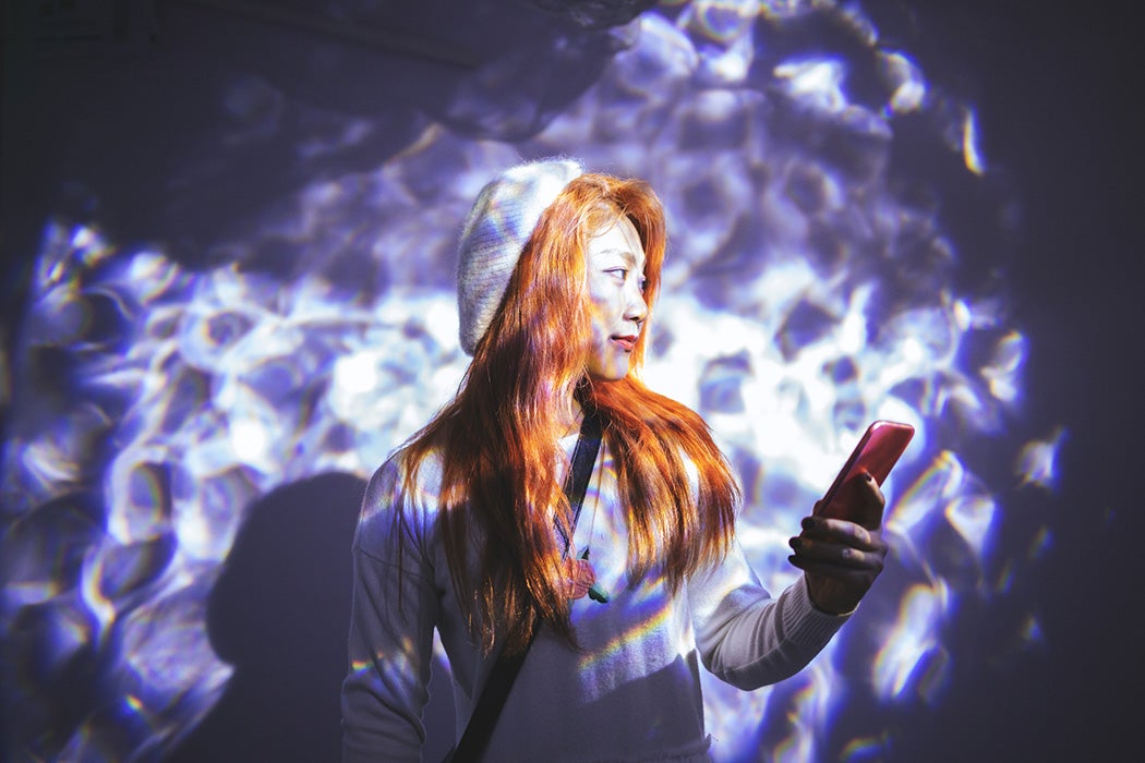 Young woman holding a cell phone