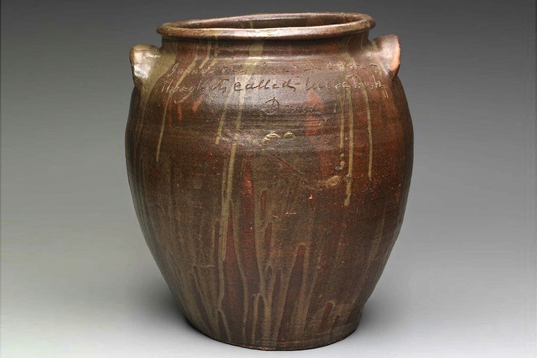 A jar by Dave the Potter, inscribed with the text, "I made this jar for cash, though it is called lucre trash"