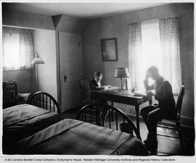 Two boys reading in the bedroom of Everyman's House