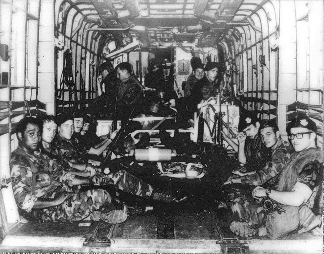U.S. Air Force security policemen assigned to the 56th Special Operations Wing, Nakhon Phanom Royal Thai Air Force Base, Thailand, aboard a Sikorsky CH-53C Super Jolly Green Giant of the 21st Special Operations Squadron. The crew of five and the 18 passengers airmen died when the helicopter crashed 64 km west of the airfield on 14 May 1975 due to a mechanical malfunction, about one hour after this photo was taken.