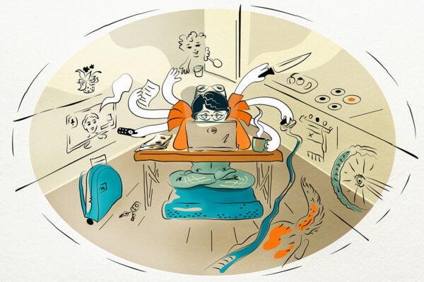 Multitasking woman at home at laptop
