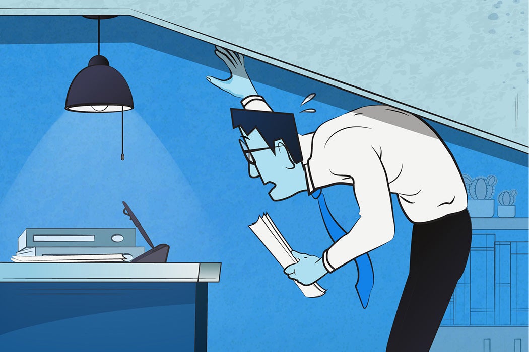 A businessman pushed against a ceiling