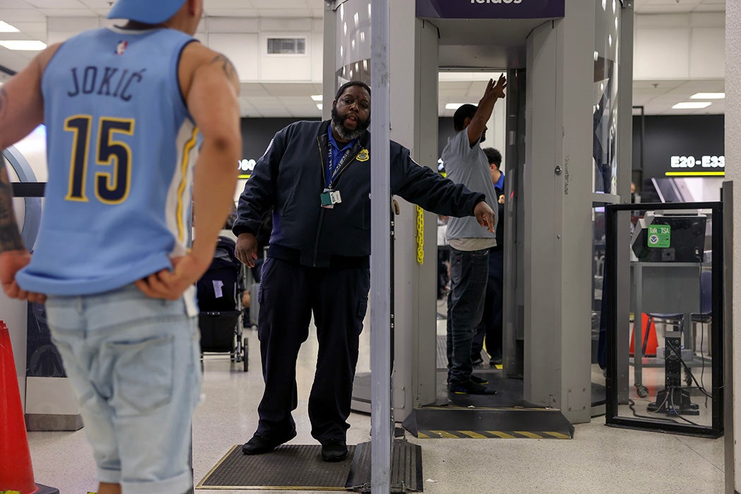Passengers pass through the TSA checkpoint at the Miami International Airport on December 17, 2024 in Miami, Florida