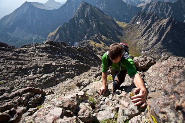 A man scrambles up a gully on the Crestone Needle in the Sangre de Cristo Mountains, Colorado.