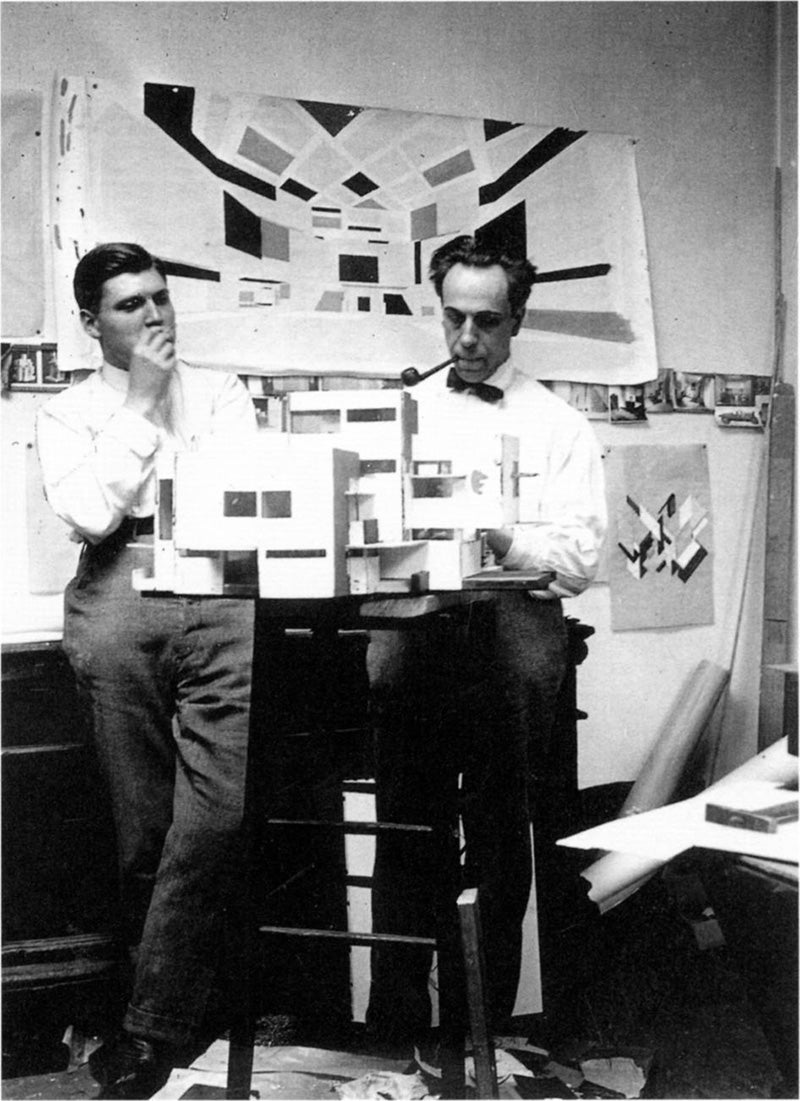 Theo van Doesburg (right) and C. van Eesteren (left) working on their architectural models in their studio in Paris, 1923