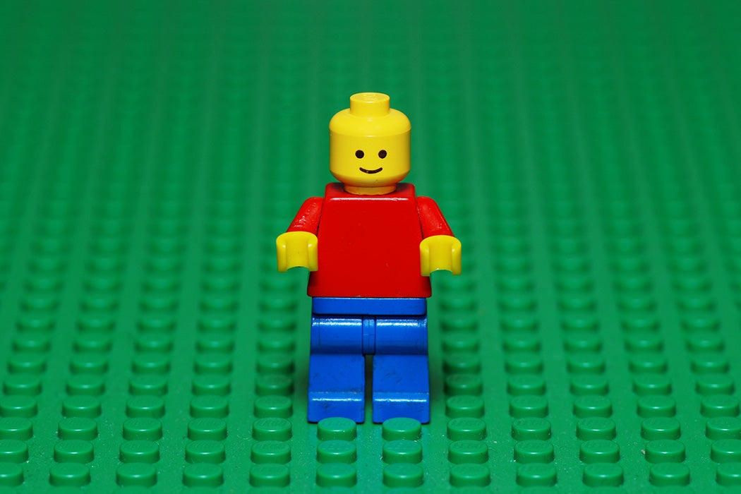 An old Lego character from the 80s on a green Lego surface.