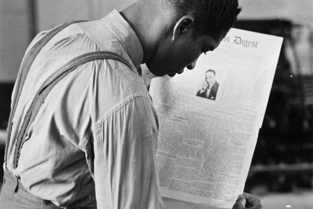 A student at Tuskegee University in Alabama learns to print a newspaper page in the Institute's printing works, ca. 1955